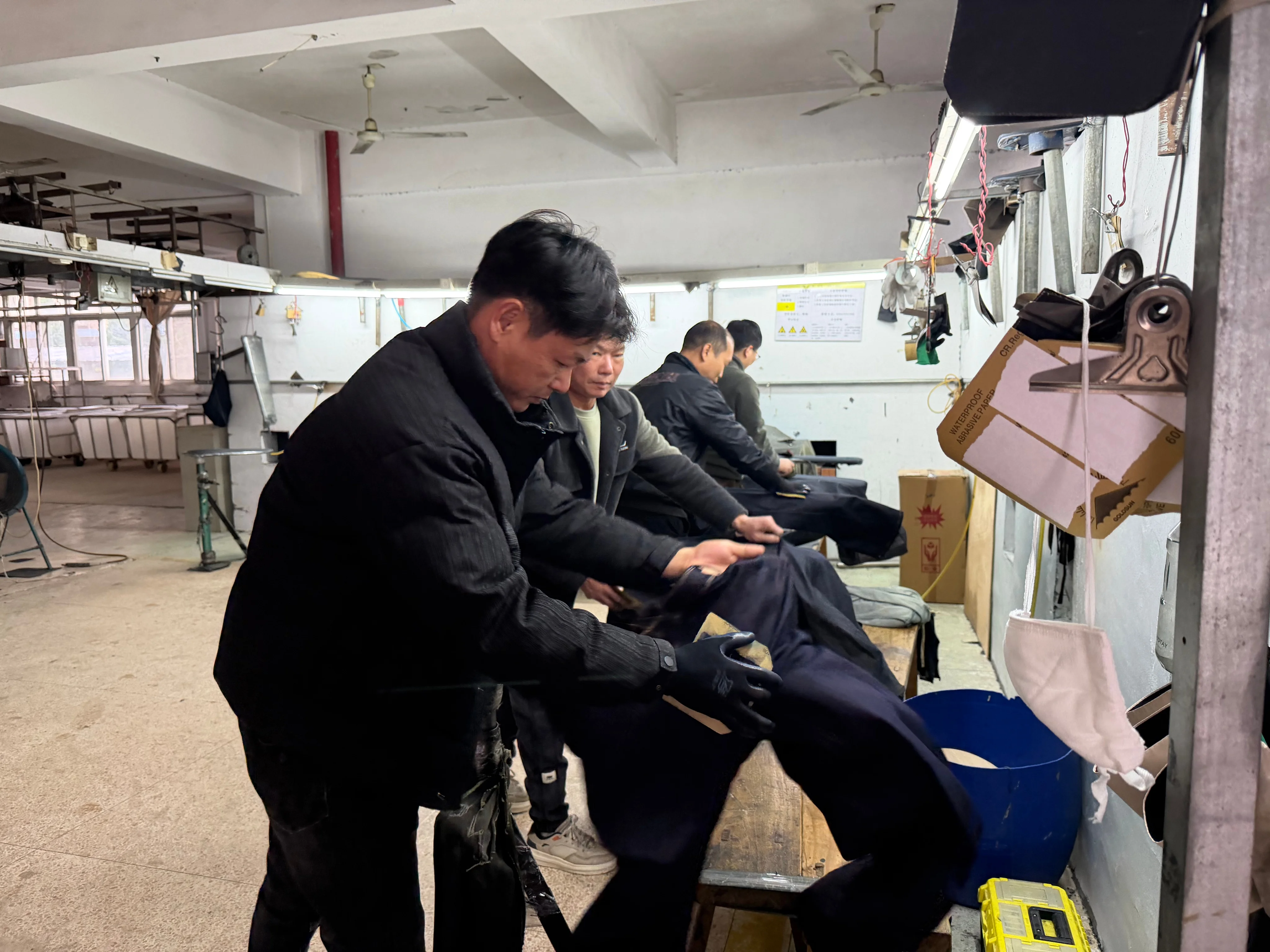 Garment workers at sewing stations in a Top Mondial facility
